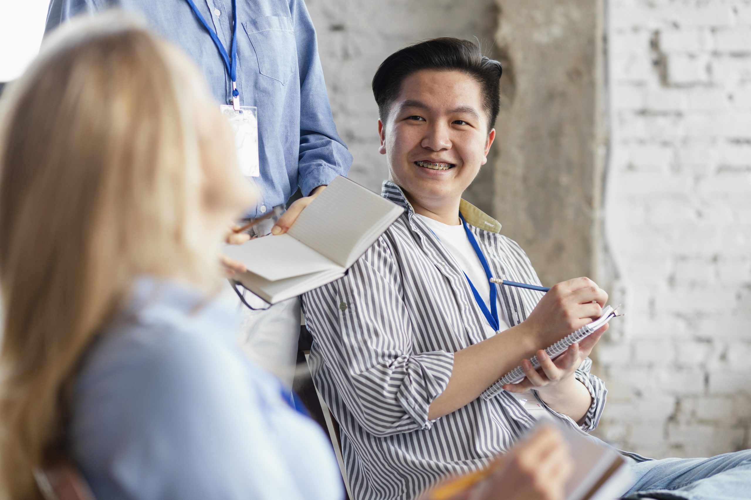 close-up-smiley-people-taking-notes